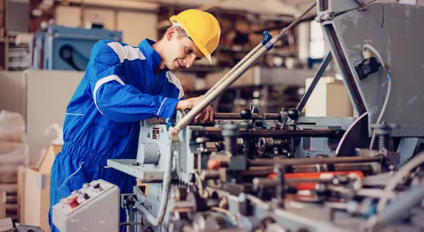 Machine operator working at an industrial machine tool