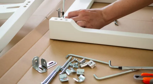 Assembling flat-pack furniture with hardware fittings